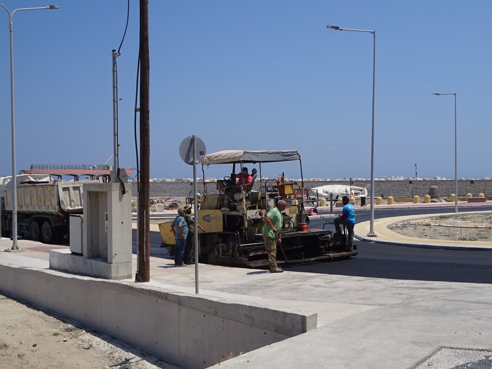 Asphalt paver laying a road surface, illustrating paving contracts